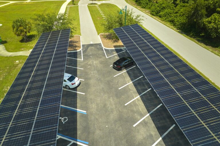 Aerial view of solar panels installed as shade roof over parking lot for parked cars