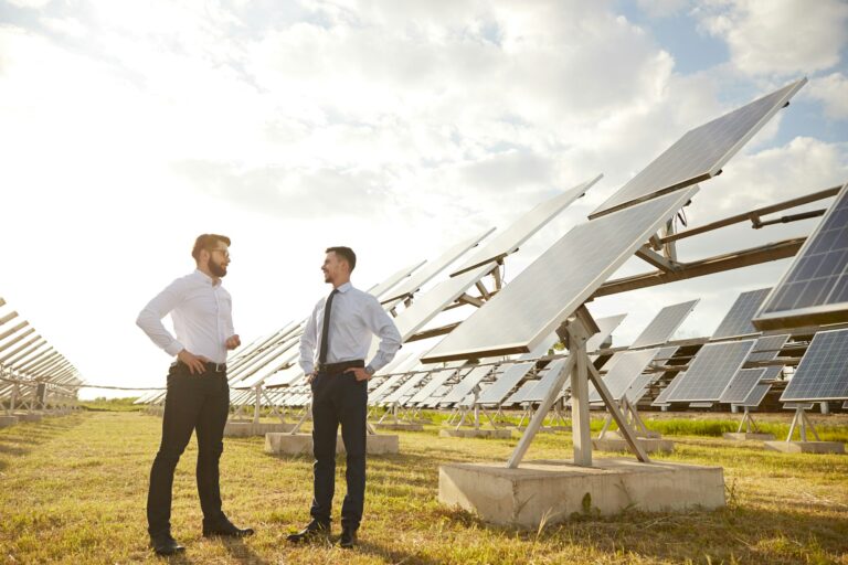 Businessmen talking on solar power plant