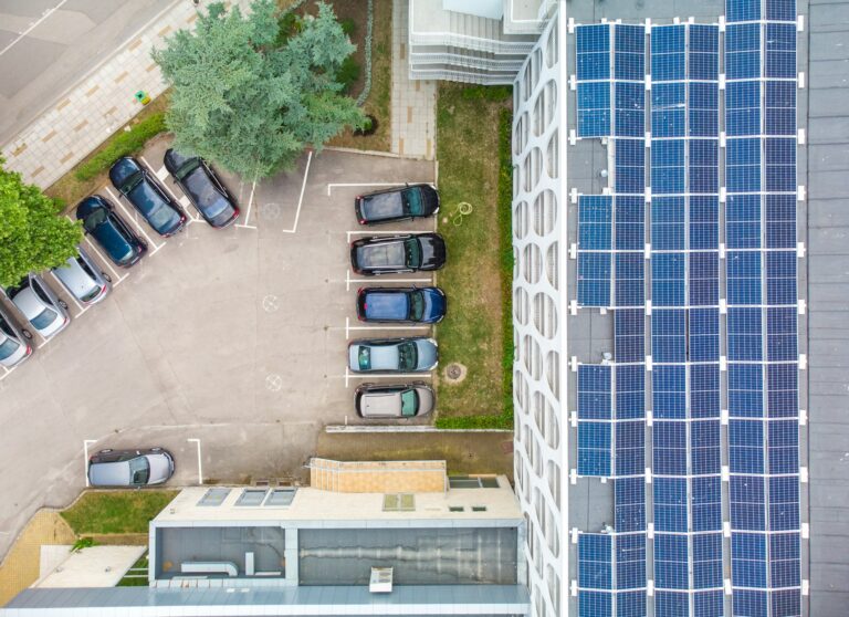 Solar panels installed on a roof of a large building. Aerial view